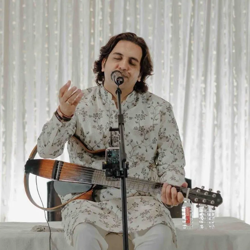 Portrait of Ankit Batra performing in a white kurta