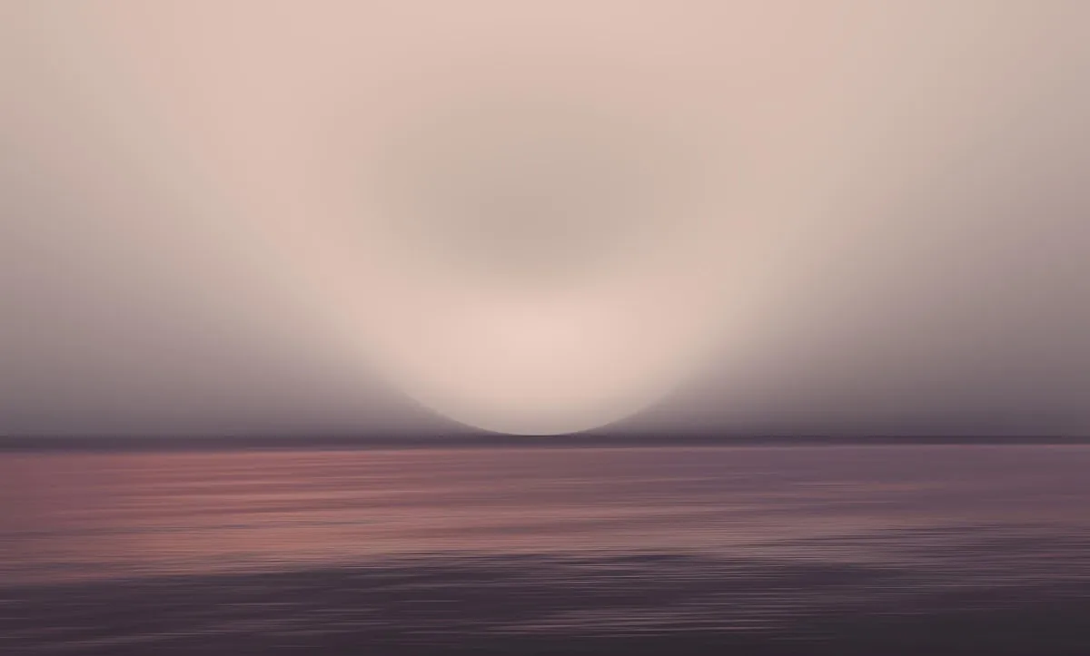 A calm sea dissolving into a soft evening horizon